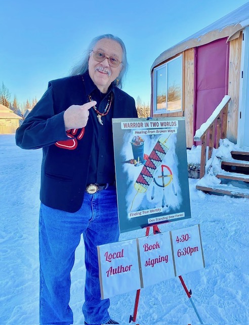An author proudly presenting his published book at a local book signing